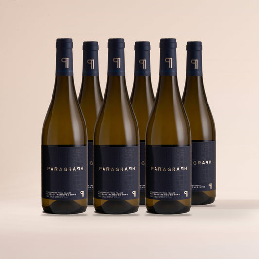 Six bottles of PARAGRAPH Chardonnay, standing on cream