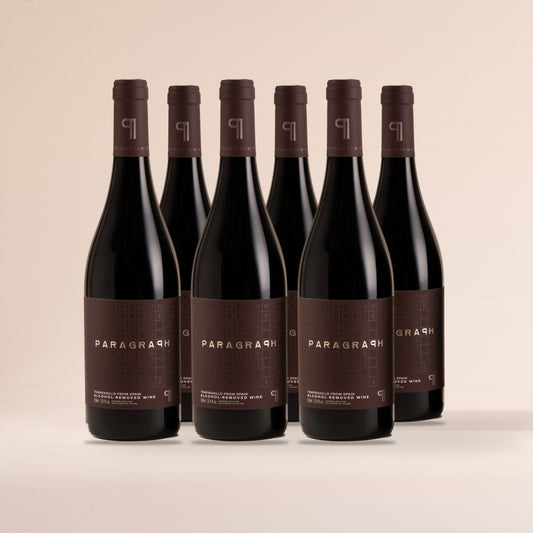 Six bottles of PARAGRAPH Tempranillo, standing on cream