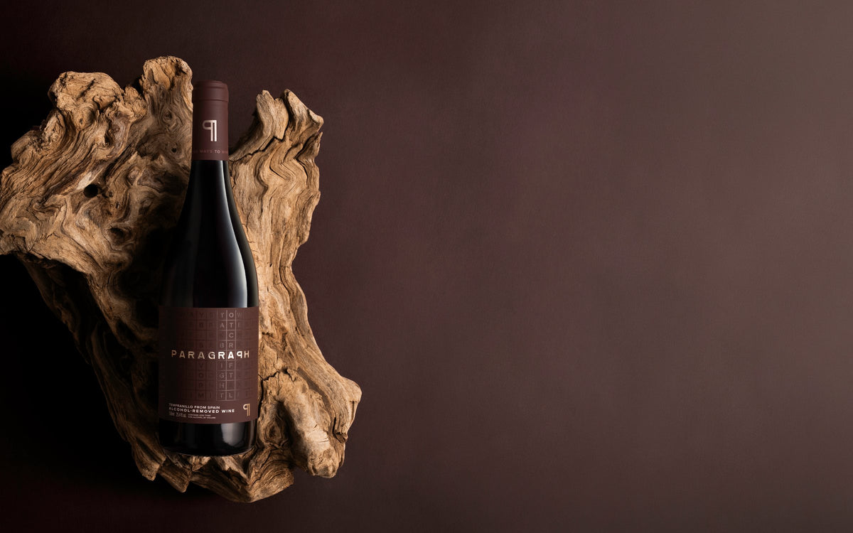 A bottle of PARAGRAPH Tempranillo on driftwood